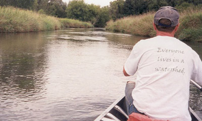 Canoeing up a stream for a Capitol Water Trails work day